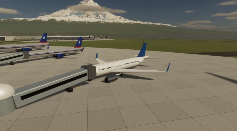 Airliner docked at a jet bridge, more at the gates, a snowy mountain on the horizon